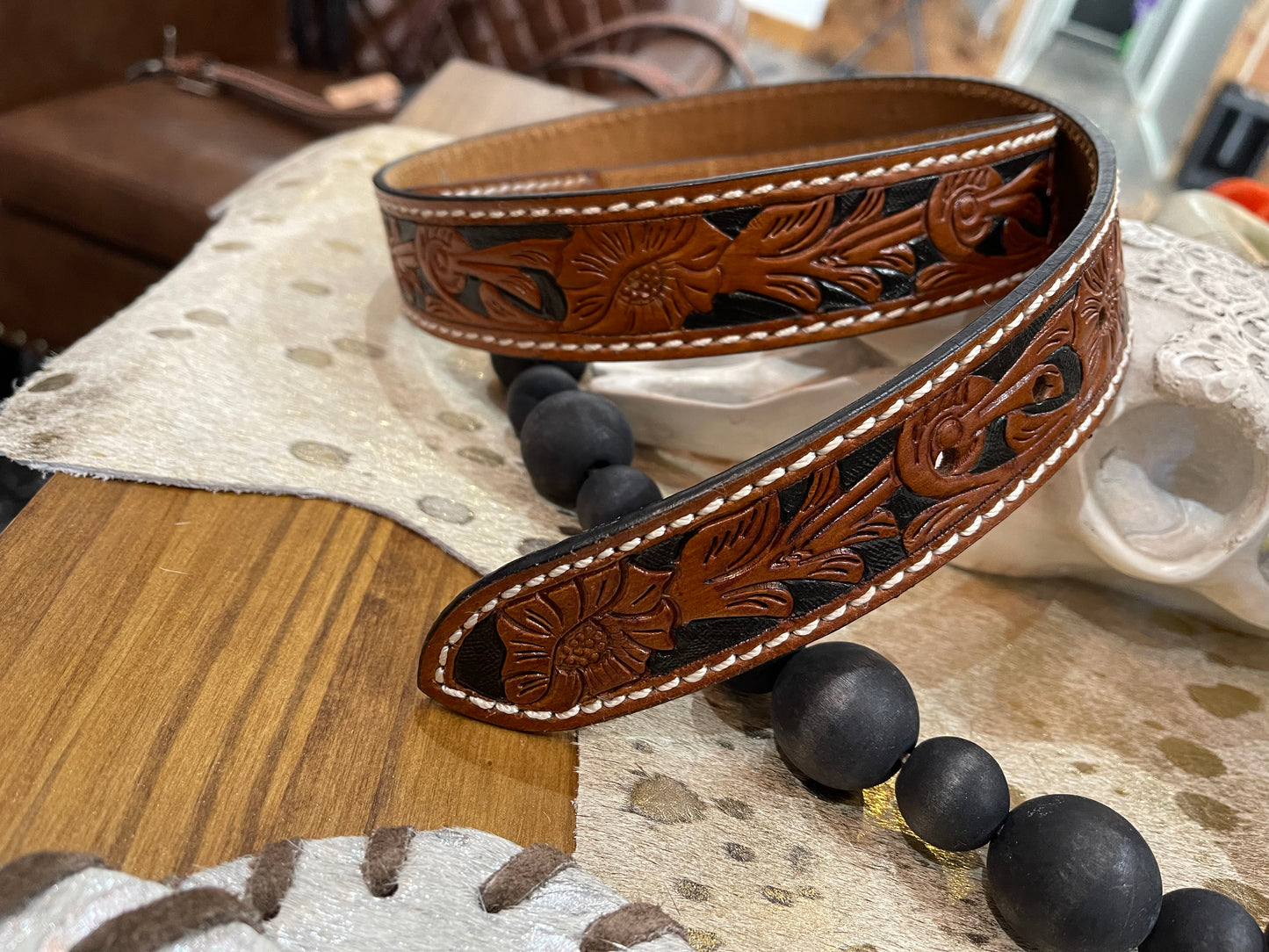 Brown and black tooled belt without buckle